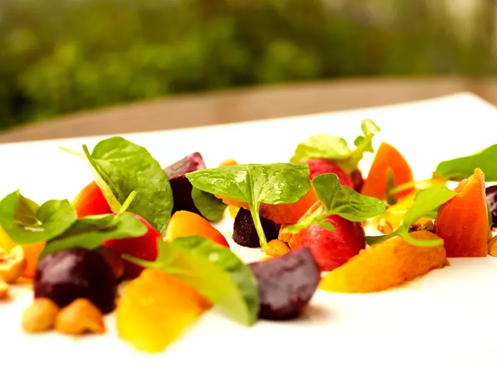 Small plate of food, beets, fruit, micro greens, etc.