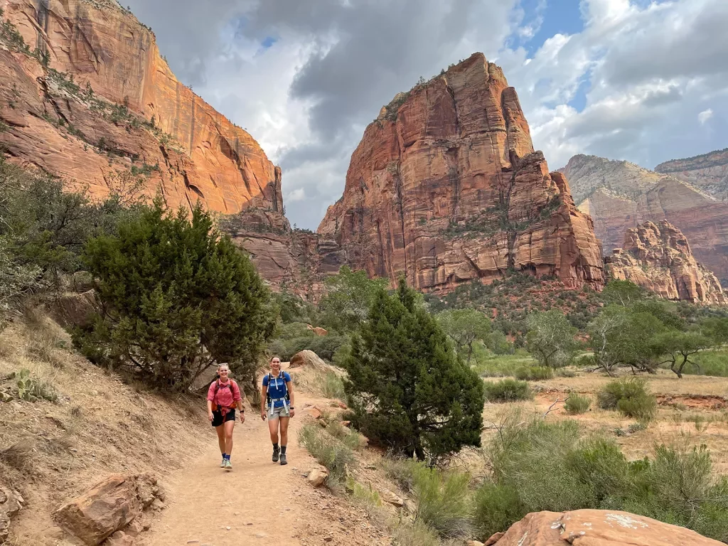 Hikers walking on trail in canyon