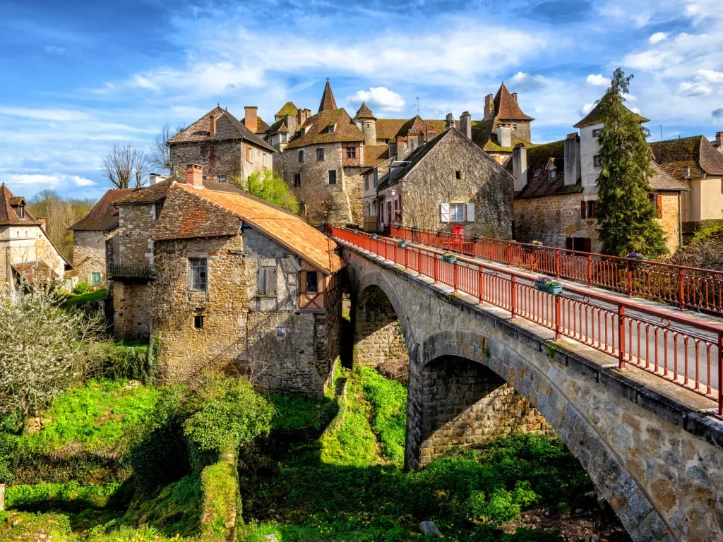 stone bridge with stone buildings in the back