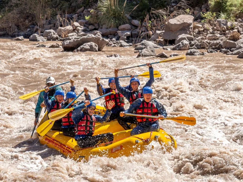 group of people white water rafting