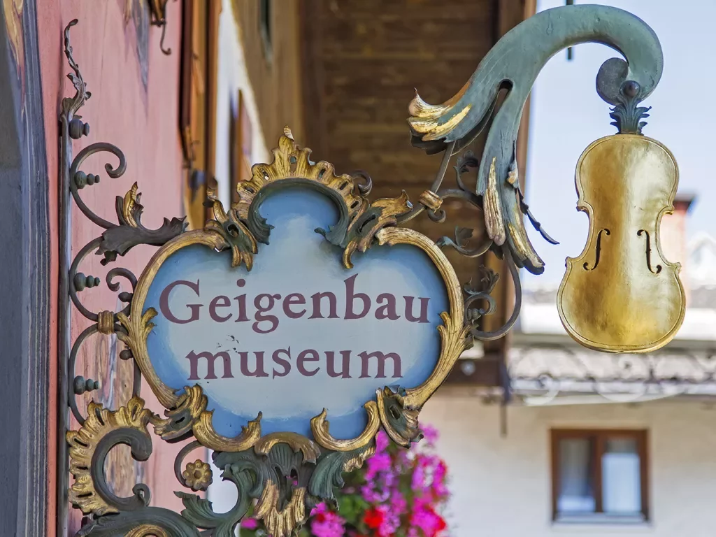 Antique Geigenbau Museum sign with a gold violin