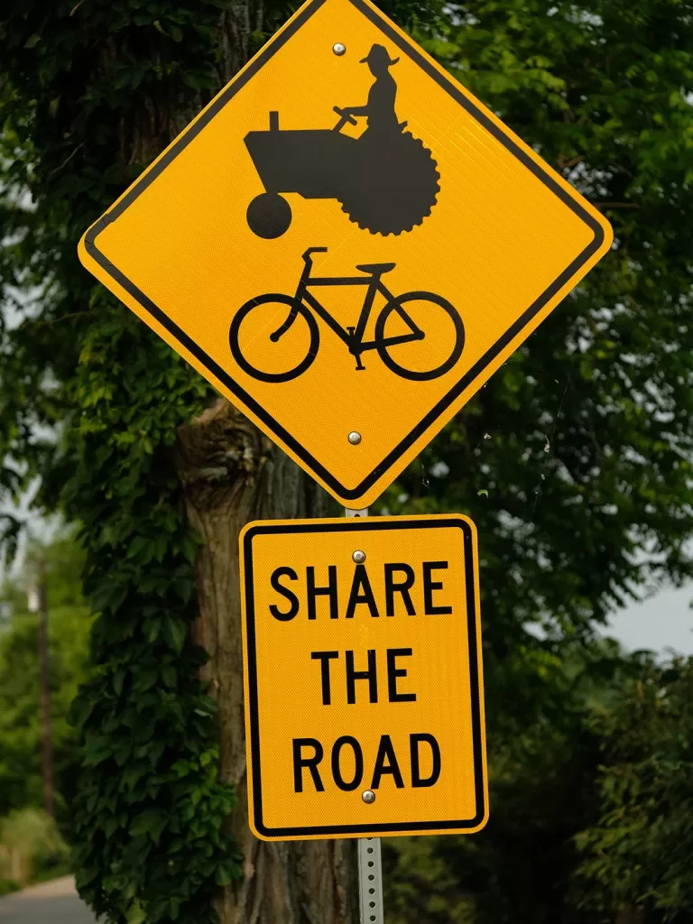 Close-up of "Share the Road" showing cyclist and tractor.