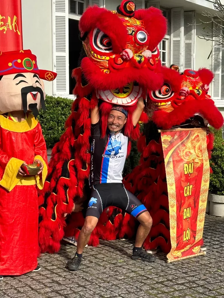 Backroads leader posing with a large dragon puppet in Vietnam