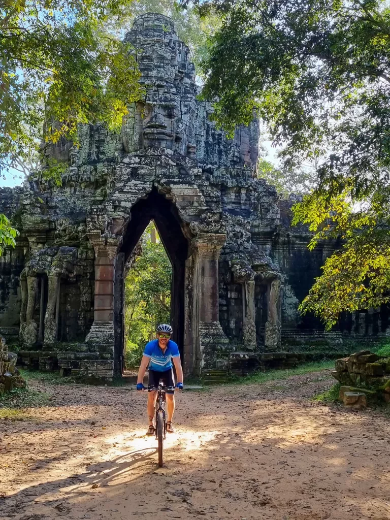Backroads guest walking in front of an arch in Angkor Wat