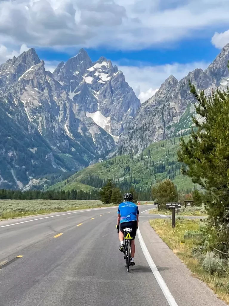 Backroads guests riding through rocky mountains on road