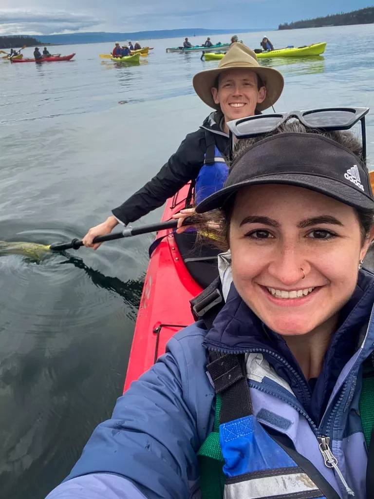 Two people smiling in a kayak