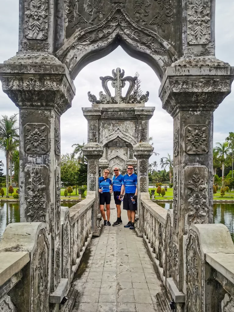 Walking along an ornate stone bridge in Bali