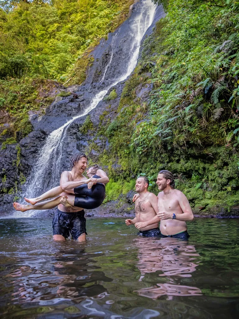 Guests Enjoying Pond in Front of Waterfall
