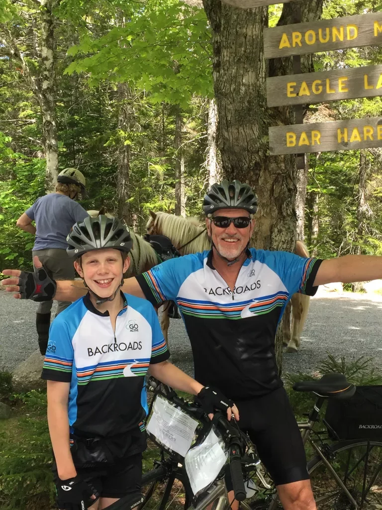 Two guests posing in front of "EAGLE LAKE"/"BAR HARBOR" sign.