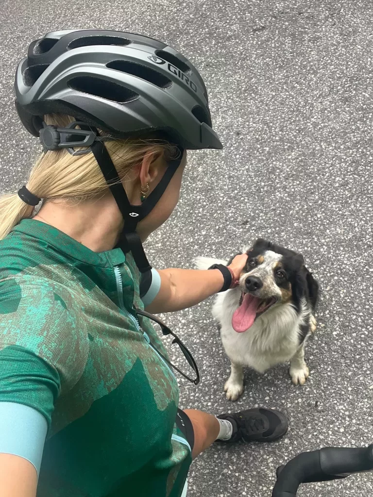 Cyclist Petting Dog