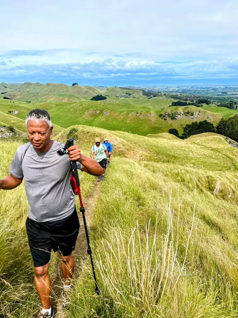 Hiking up a grassy hill in New Zealand