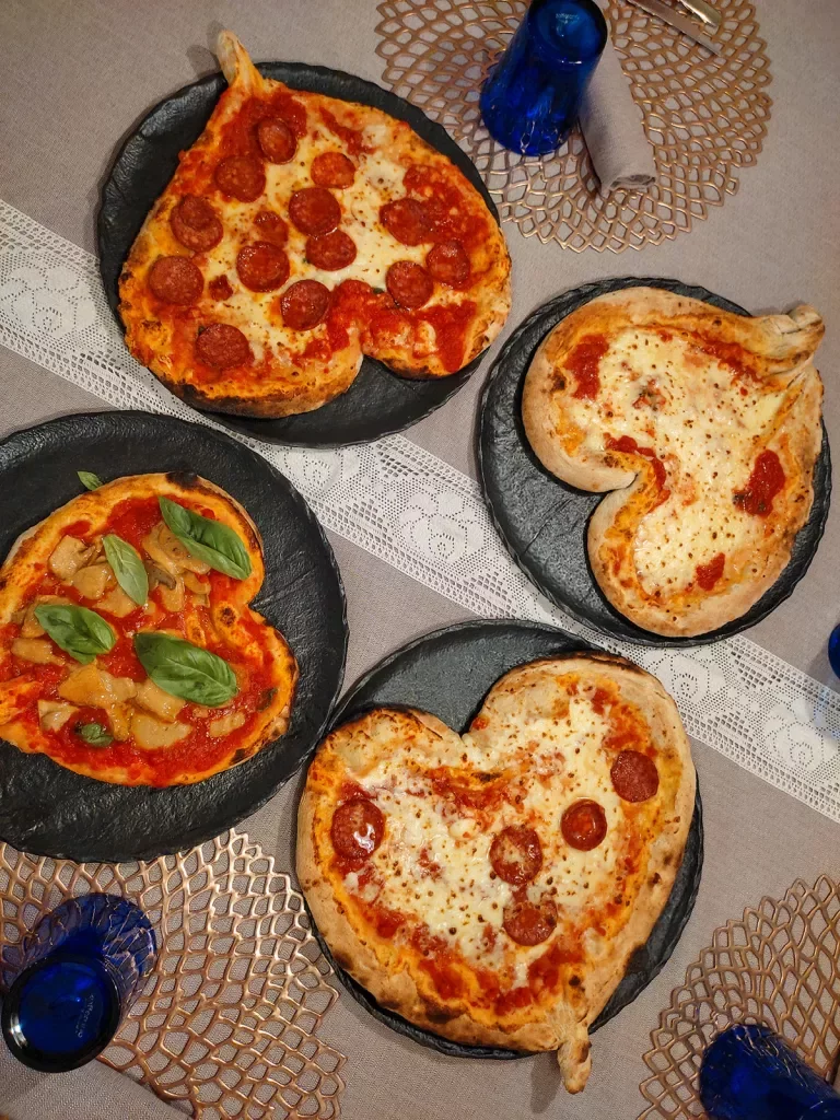 Four heart-shaped pizzas.