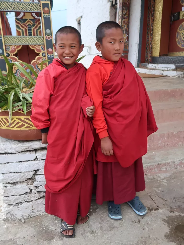 Two young monks in red robes in Bhutan