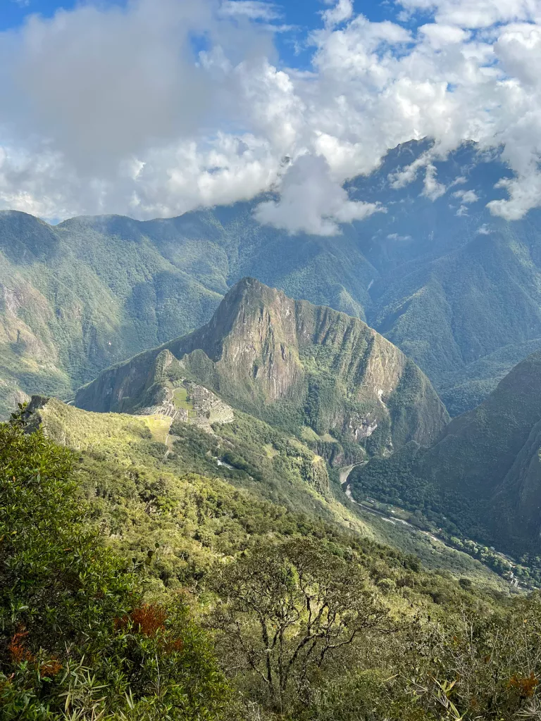 Wide shot of mountain range, sky, clouds, trees, etc.