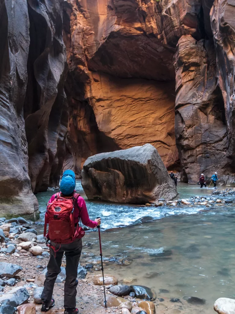 Guest in stream of canyon in Zion + Bryce