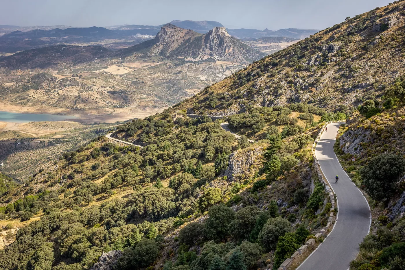 Two Backroads' guests biking on road in mountains, Spain.