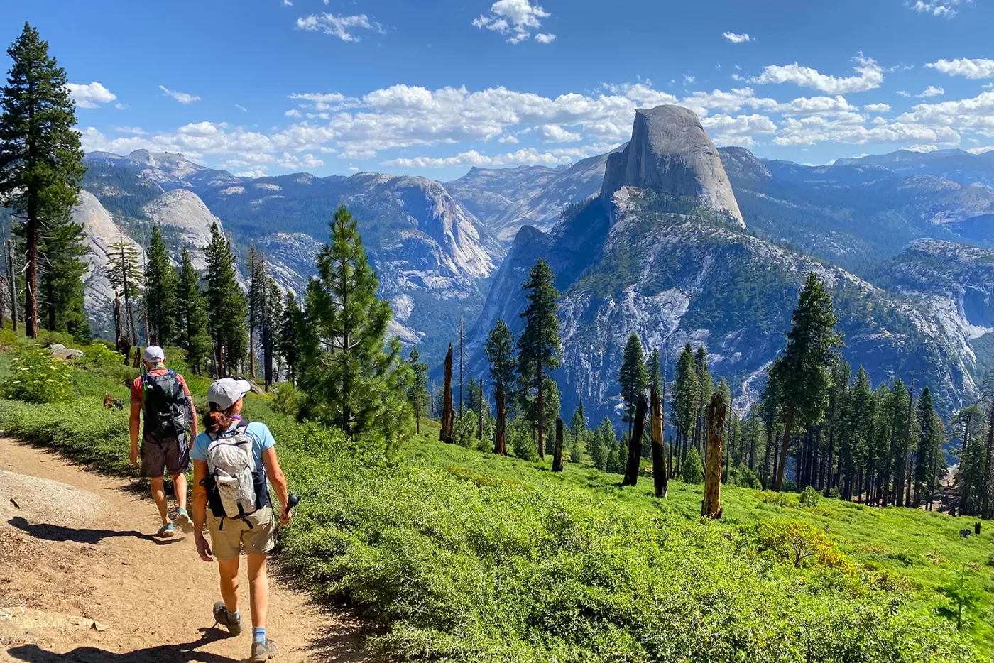 Guests hiking with Glacier Point in background.